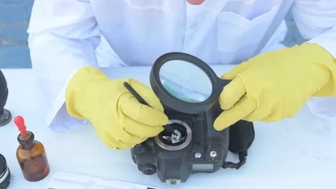 Elderly solid person in white dressing gown, cap, medical mask, glasses clean Stock Footage 93429270