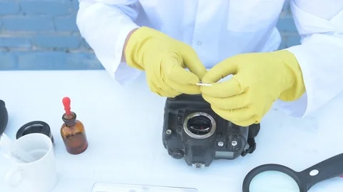 Elderly solid person in white dressing gown, cap, medical mask, glasses clean Stock Footage 93429284