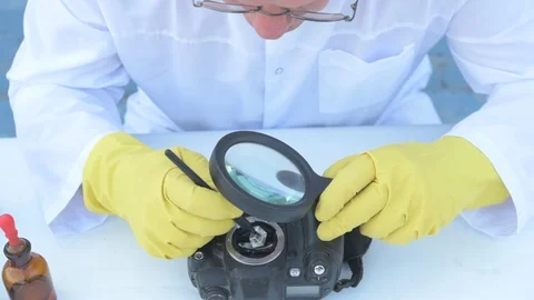 Elderly solid person in white dressing gown, cap, medical mask, glasses clean Stock Footage 93429329