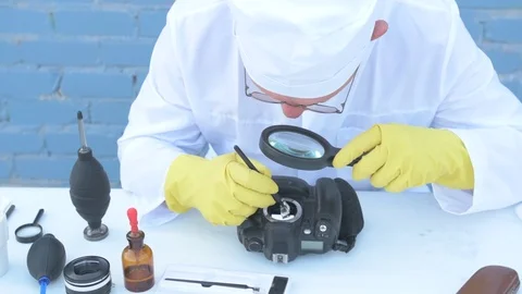 Elderly solid person in white dressing gown, cap, medical mask, glasses clean Stock Footage 93429381