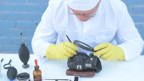 Elderly solid person in white dressing gown, cap, medical mask, glasses clean Stock Footage 93429398