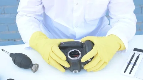 Elderly solid person in white dressing gown, cap, medical mask, glasses clean Stock Footage 93429517