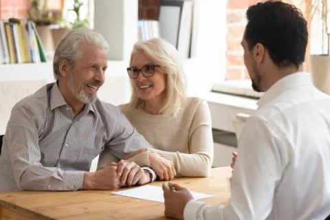 Elderly spouses during meeting with banker or real estate agent Stock Photos