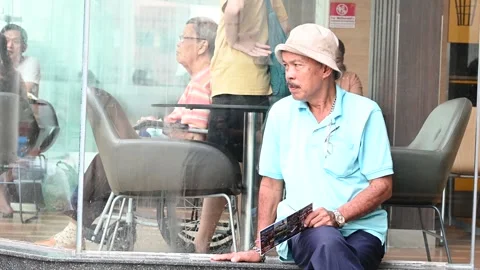 An elderly is taking a rest Stock Footage 240300800