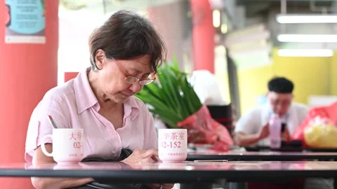 An elderly is taking a rest Stock Footage 240383704