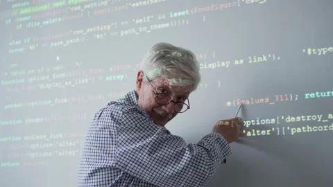 Elderly teacher explaining code for camera Video stock 142494388