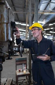 An elderly technician uses a computer to test the operation control of a s... Stock Photos