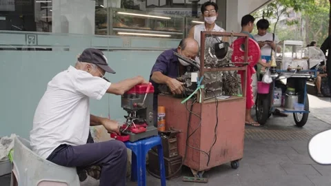 Elderly Thai men working in a tiny street workshop Stock Footage 327372918