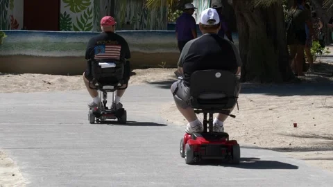 Elderly white americans using motorized scooters for transportation Stock Footage 257040242