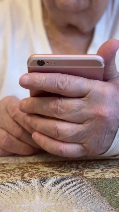 Elderly woman with broken arm width cast for the arm sitting at beige couch Stock Footage 301338929
