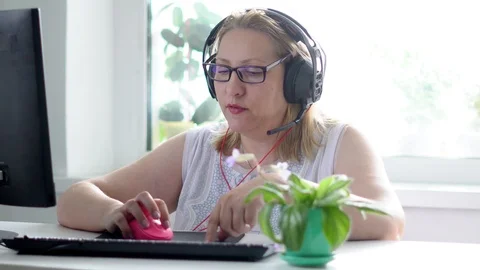 An elderly woman at the computer Stock Footage 98286819