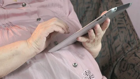 Elderly woman with digital tablet computer indoors Vídeo Stock 69724544