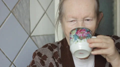 Elderly woman drinking tea Stock Footage 34896745