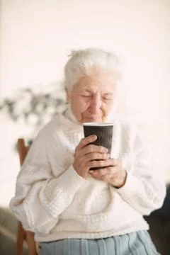 Elderly woman drinks hot tea Stock Photos