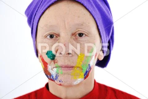 Elderly woman grandmother with painted face over white background Stock Photos