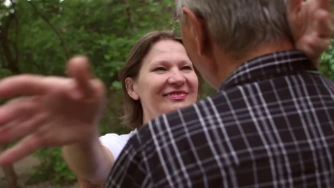 Elderly woman hugging her husband close-up in park Stock Footage