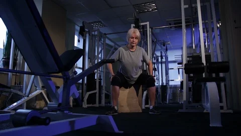 Elderly woman performs isometric exercise, kneeling to the sides and back.front Stock Footage 115246024