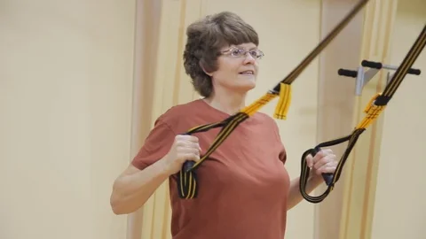 Elderly woman pulling up, doing physiotherapy exercises in fitness room. Healthy 動画素材 81269461