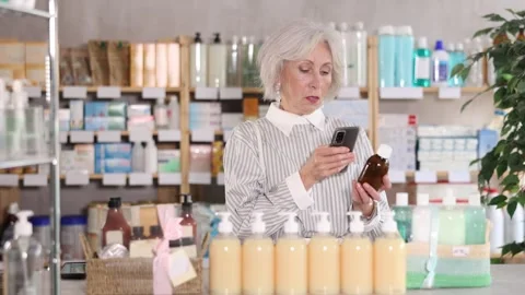 Elderly woman scanning qr code of syrup Stock-Footage 321722672