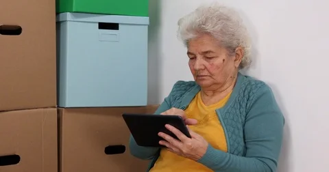 Elderly Woman Sitting Floor Browsing Digital Tablet New Home Property Apartment Stock Footage