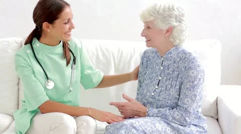 Elderly woman speaking with home nurse Stock Footage