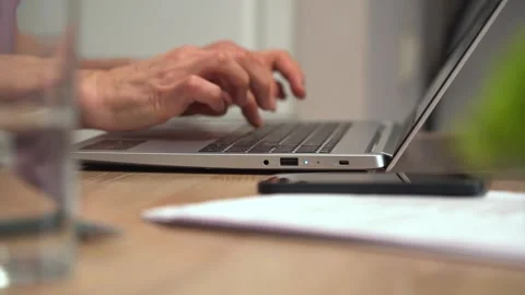 Elderly woman typing text while learning the functions of a text editor Stock Footage 301585927