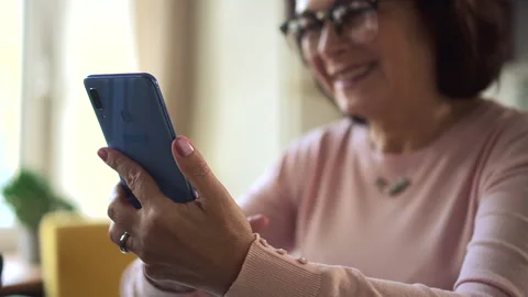 Elderly woman using device at desk and spending good day in apartment during Stock Footage 156757352