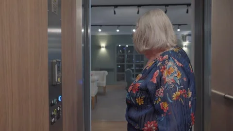 Elderly Woman Using Elevator in French Retirement Home Stock Footage 258453404