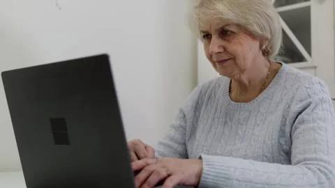 Elderly woman using laptop computer Stock Footage 321855877