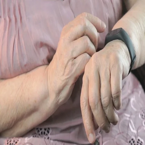 The elderly woman using the smart fitness tracker Stock Footage