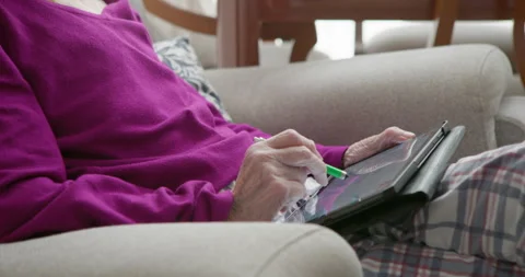Elderly woman using tablet computer Video stock 337220947