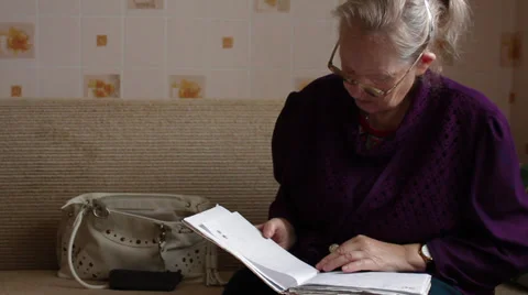 Elderly woman versed in documents Stock Footage 32554095
