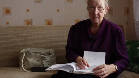 Elderly woman versed in documents Stock Footage 32554936