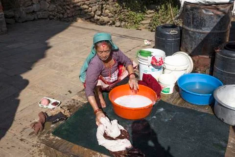 Elderly woman washes the dirty laundry in kathmandu, nepal Stock Photos