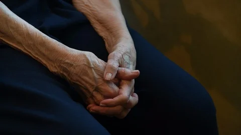 Elderly woman's clasped hands with copy space Stock Footage 94336548