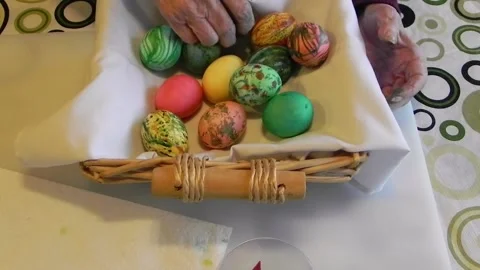 Elderly Woman's Hand rearranging Easter Eggs Stock Footage 150269260