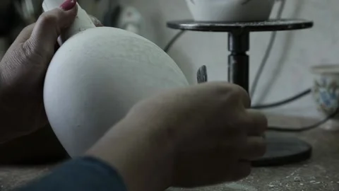 An elderly womans hand scrapes the surface of the jug. Slow panorama up. Video stock 130526253