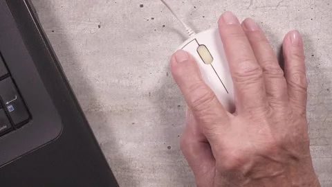 An elderly woman's hand uses a computer mouse top view Video stock 93035561