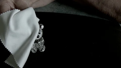 Elderly womans hands gently wipe small crystal bear_Not B&amp;W Vidéo 72150000