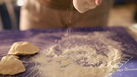 Elderly woman's hands kneading dumpling dough on a special silicone mat. Stock Footage 168182514