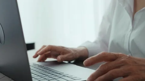 An elderly woman's hands typing on a keyboard close-up. Stock Footage 242140965