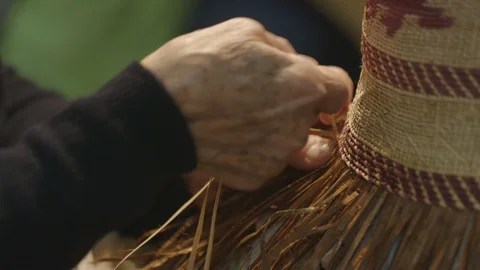 Elderly womans hands weaving a straw hat Stock Footage 104867548