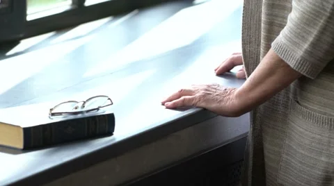 Elderly woman's hands on windowsill 스톡 동영상 63431447