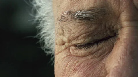 Elderly wrinkled man half face portrait: closeup on old man's eye  Stock Footage 58301744