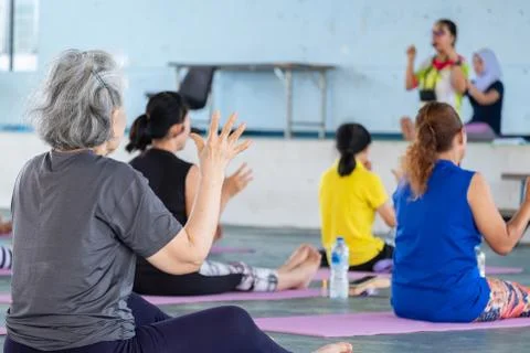 Elderly in a yoga exercise posture Stock Photos