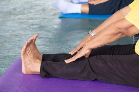 Elderly in a yoga exercise posture Stock Photos