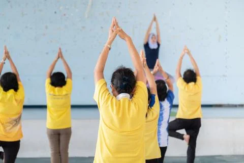Elderly in a yoga exercise posture Stock Photos