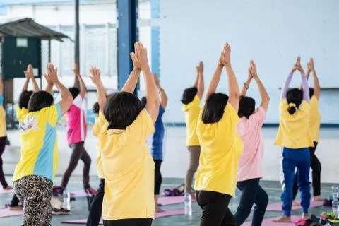 Elderly in a yoga exercise posture Stock Photos