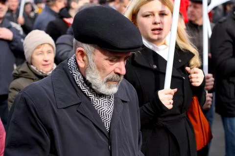 An elderman with white beared and black cap on a political march Stock Photos