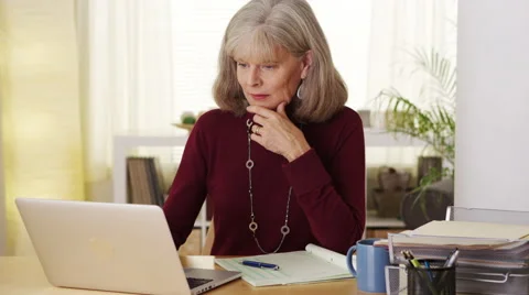Eldery woman using laptop computer taking notes smiling Stock-Footage 47374705
